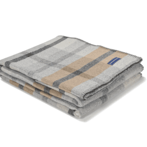 Two folded plaid scarves with neutral tones on white background.