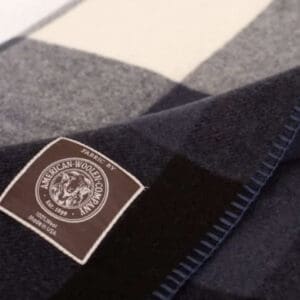 Close-up of a woolen fabric with a label featuring an emblem and text.