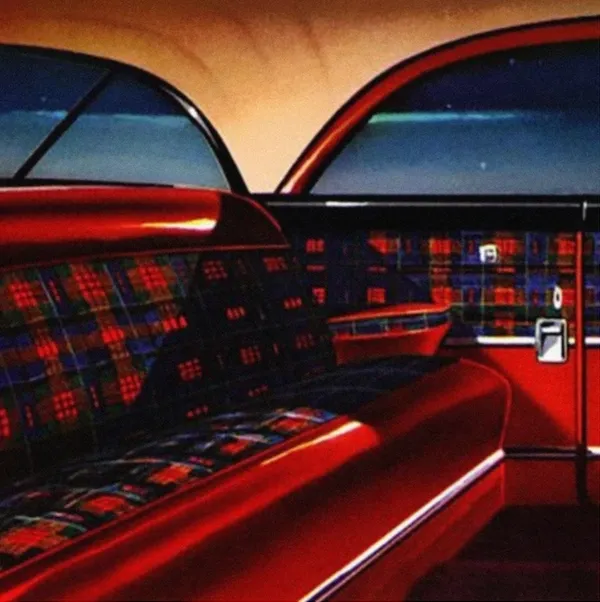 Interior of a vintage car with red plaid seats and curved windows.