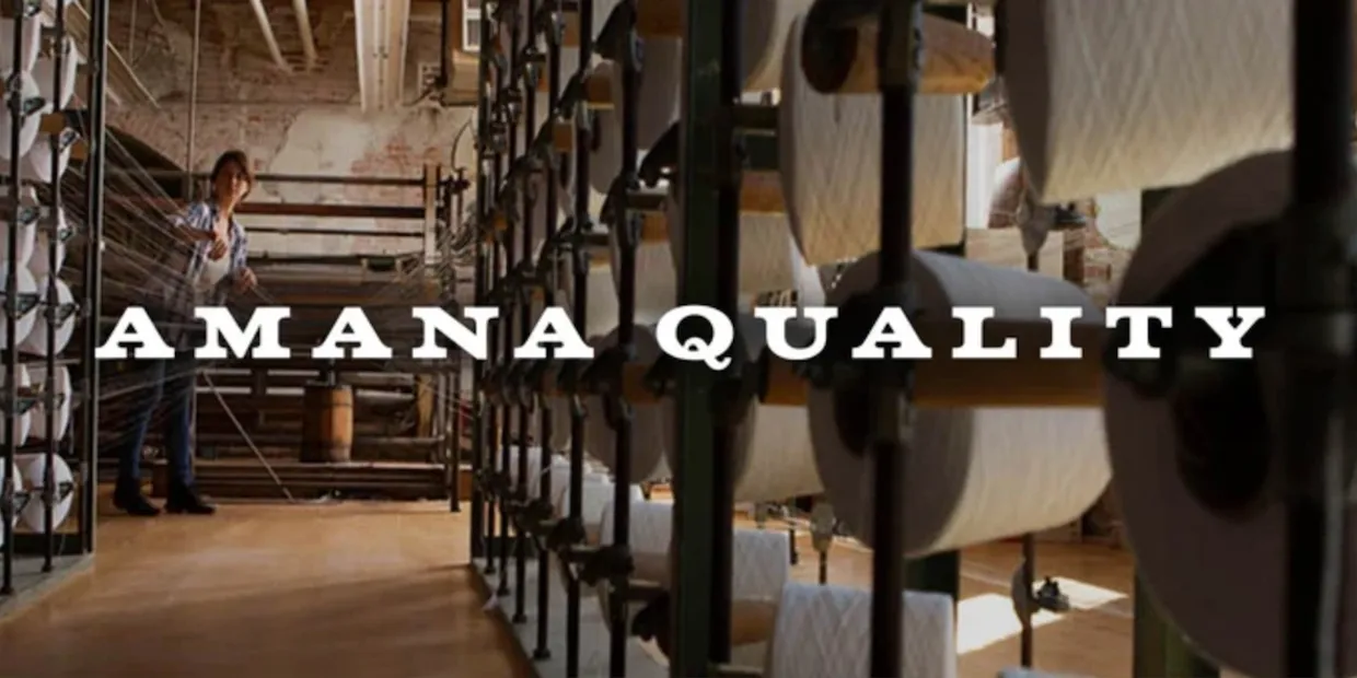 Rows of cheese wheels aging on shelves in a cellar with 'PARMIGIANO REGGIANO' text.