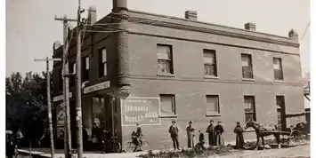 Historic photo of the Liberal Club in Newport with people gathered outside.