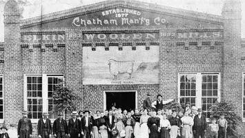 Historic photo of Chatham Manufacturing Co. with crowd gathered outside.