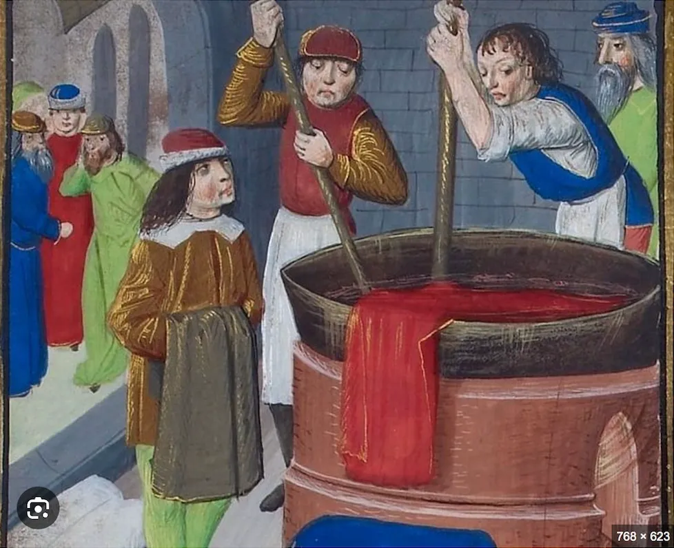 Medieval scene with men around a large cauldron and a red cloth.