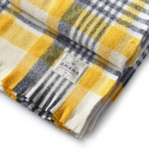 Yellow and gray plaid wool blanket folded.
