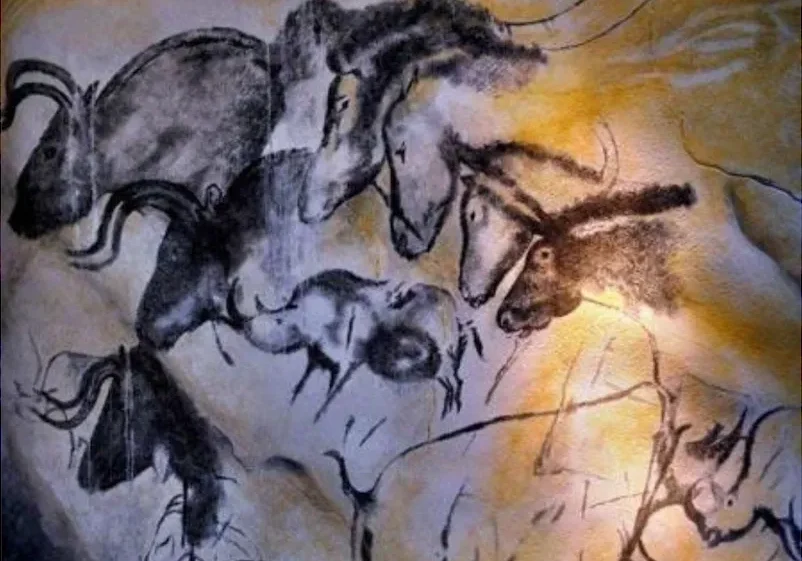 Ancient cave painting depicting various wild animals in naturalistic style.
